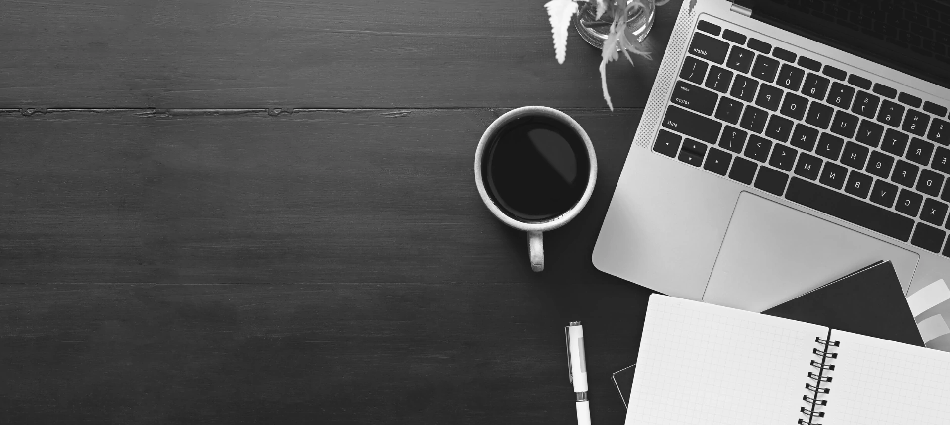 the completely unoriginal photo of a laptop, a mug of coffee, and a notebook